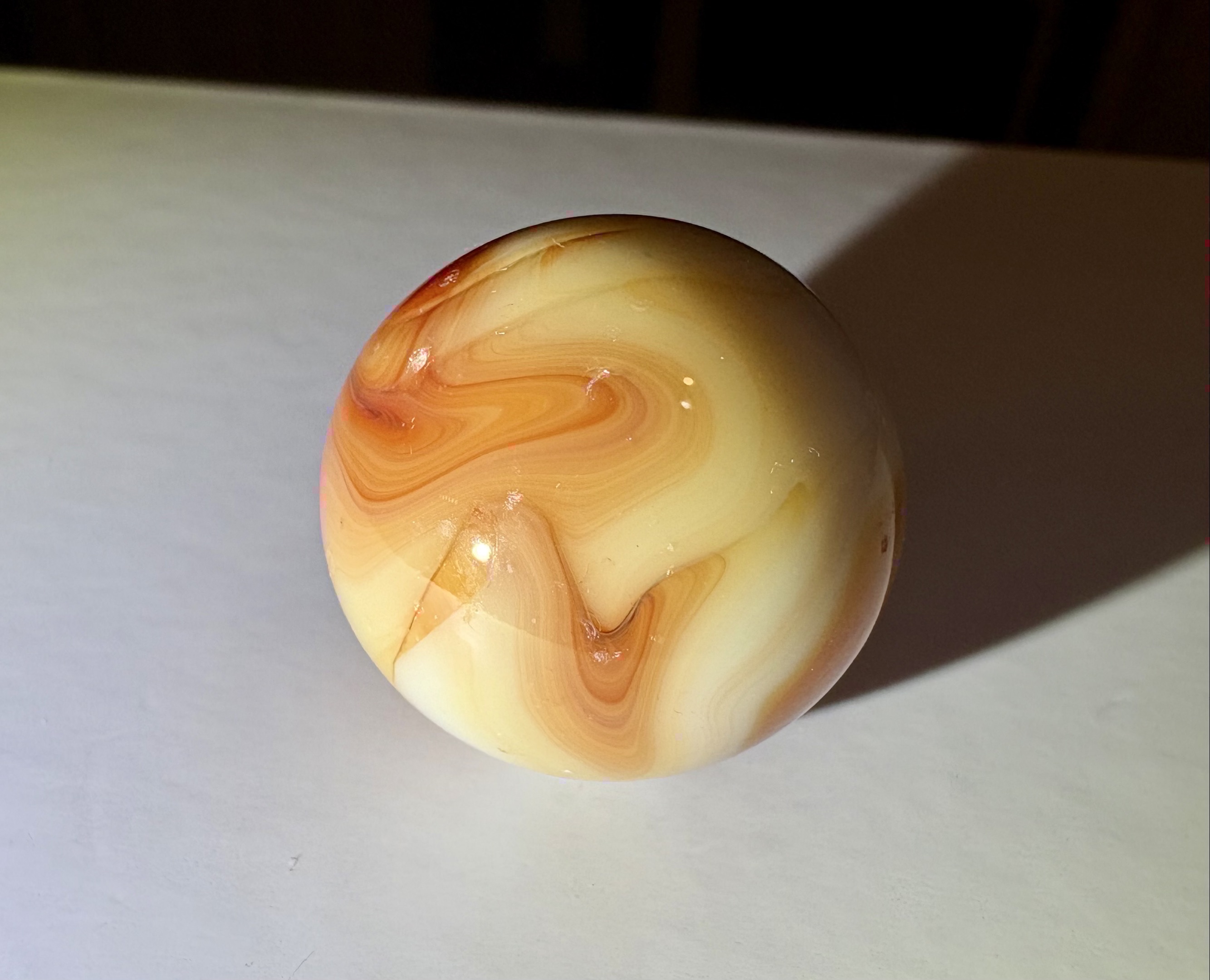 Orange Slag Shooter by Akro Agate Company, identification view