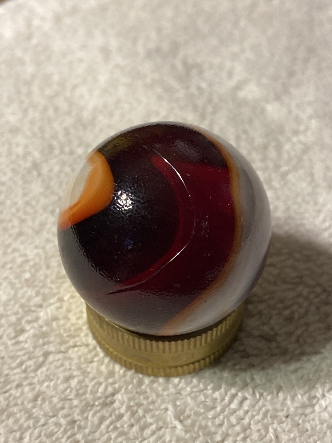 Silver Oxblood (with Orange Accent) by Akro Agate Company, identification view