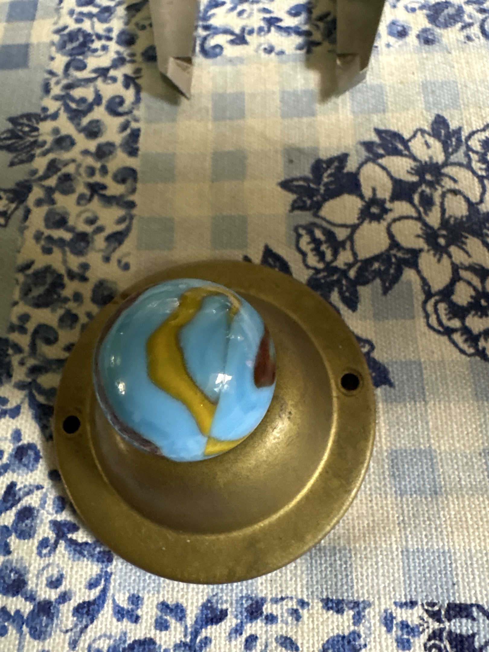 Opaque light blue base with yellow and dark red/brown patches by Akro Agate, identification view