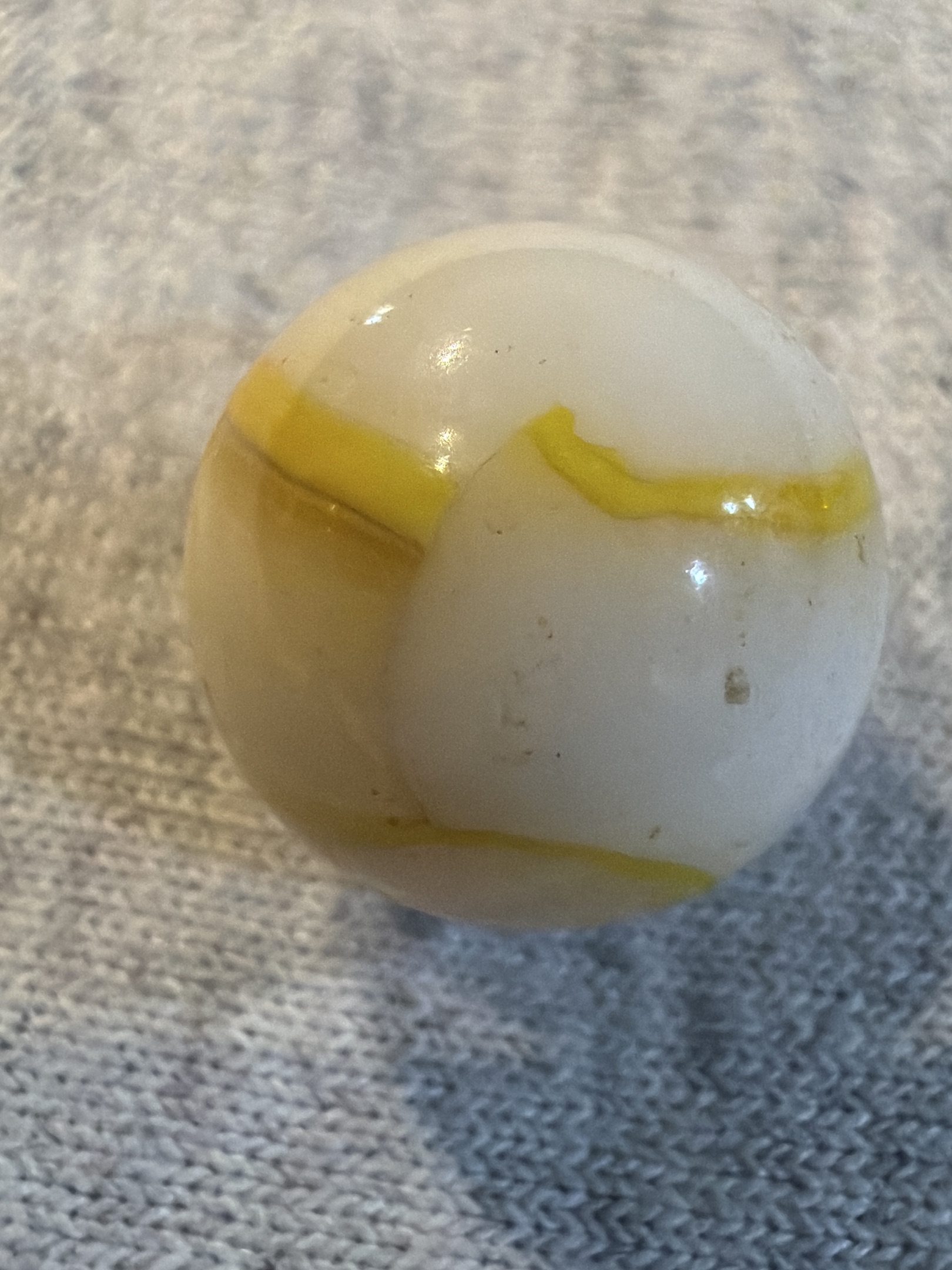 White with Yellow Stripe Game Marble by Vitro Agate Company, identification view