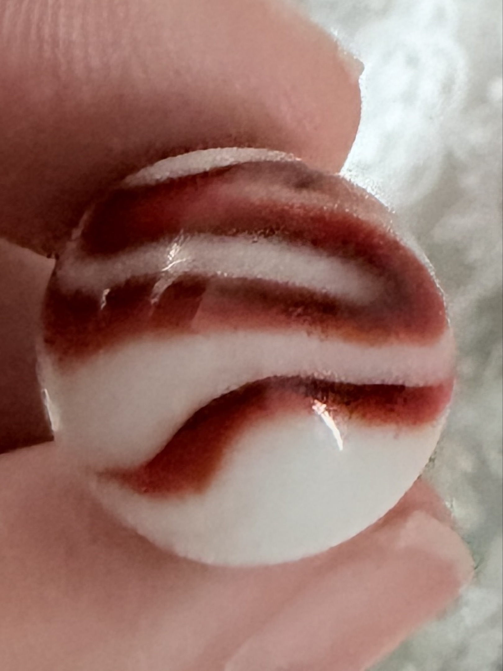 Red and White Peppermint Corkscrew by Akro Agate, identification view