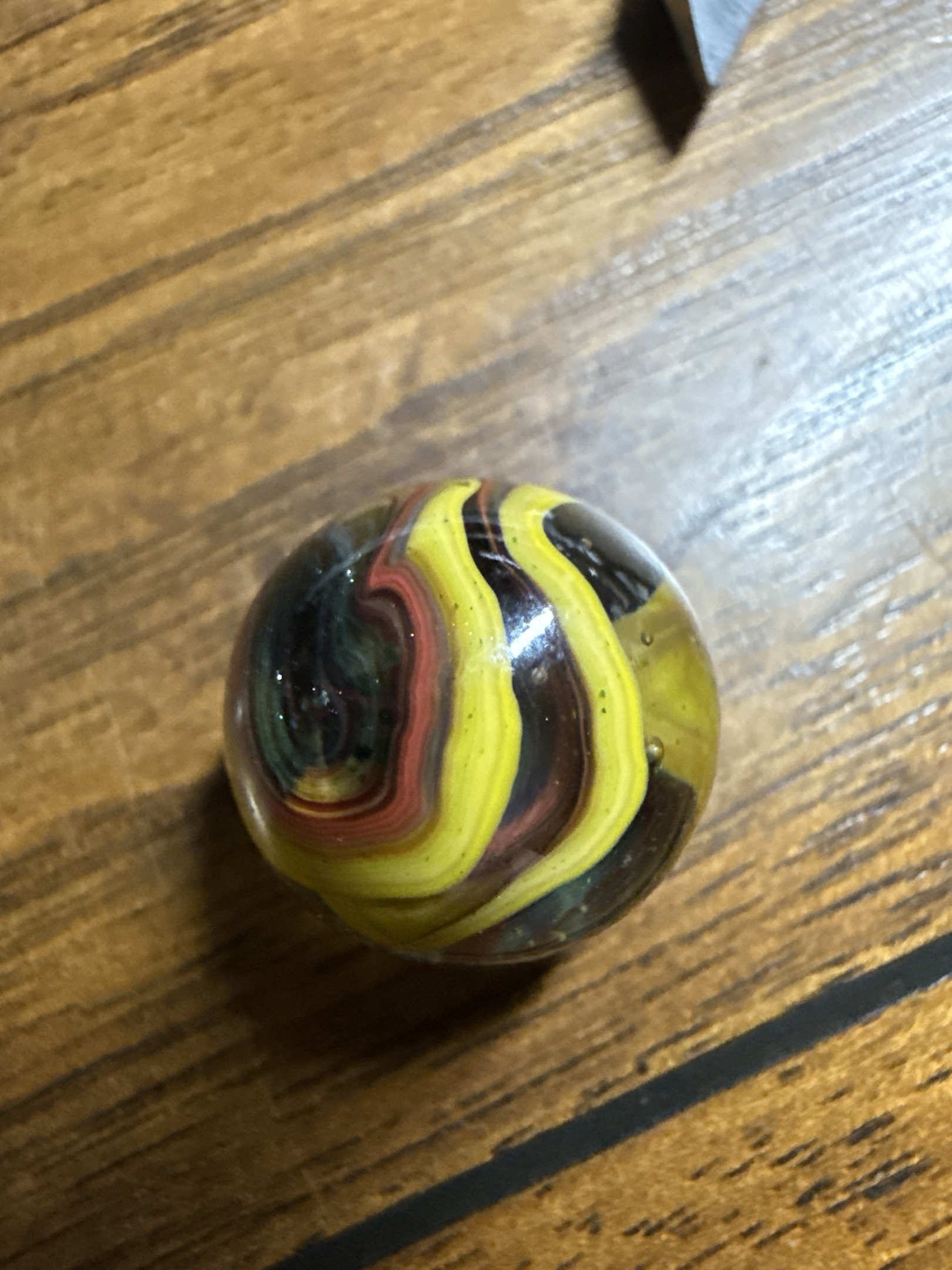 Yellow and Black Swirl with Oxblood by Akro Agate Co., identification view