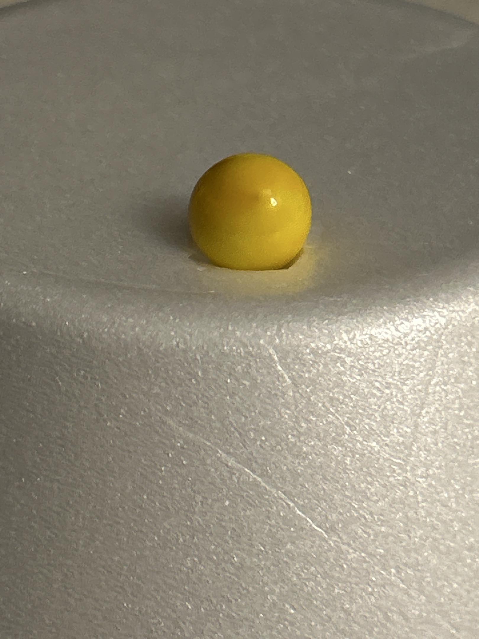 Yellow Peewee Game Marble by Peltier Glass Company, identification view