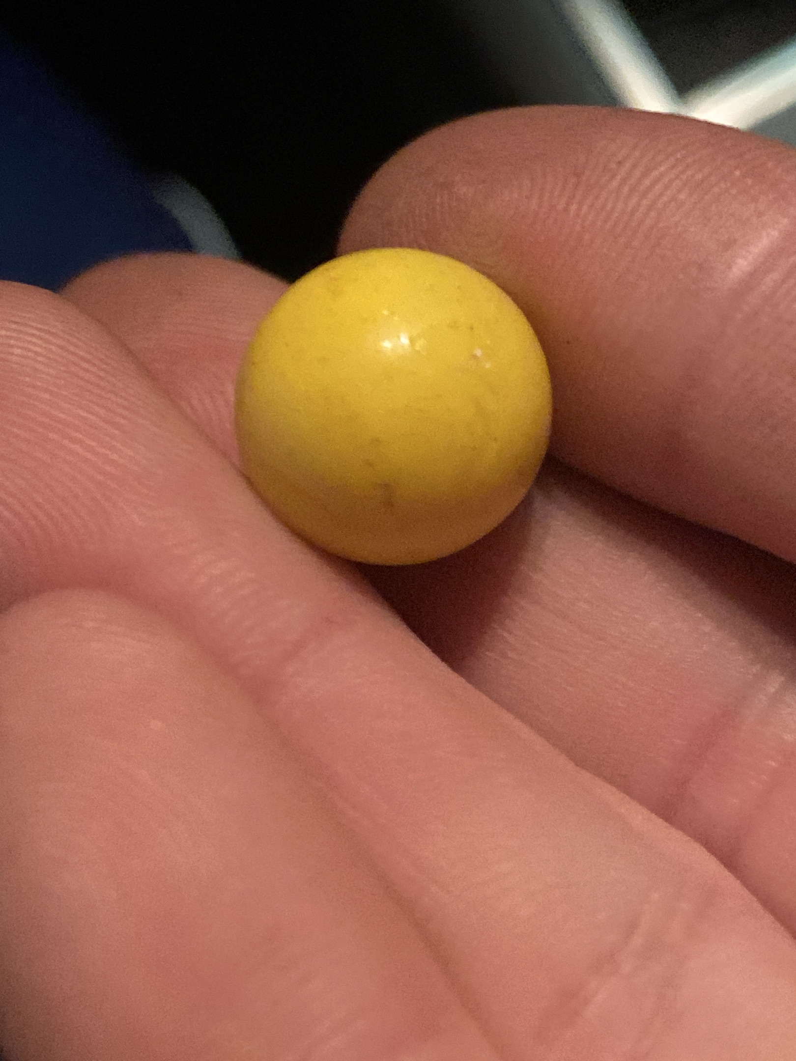 Solid Yellow Opaque Shooter by Akro Agate Company, identification view