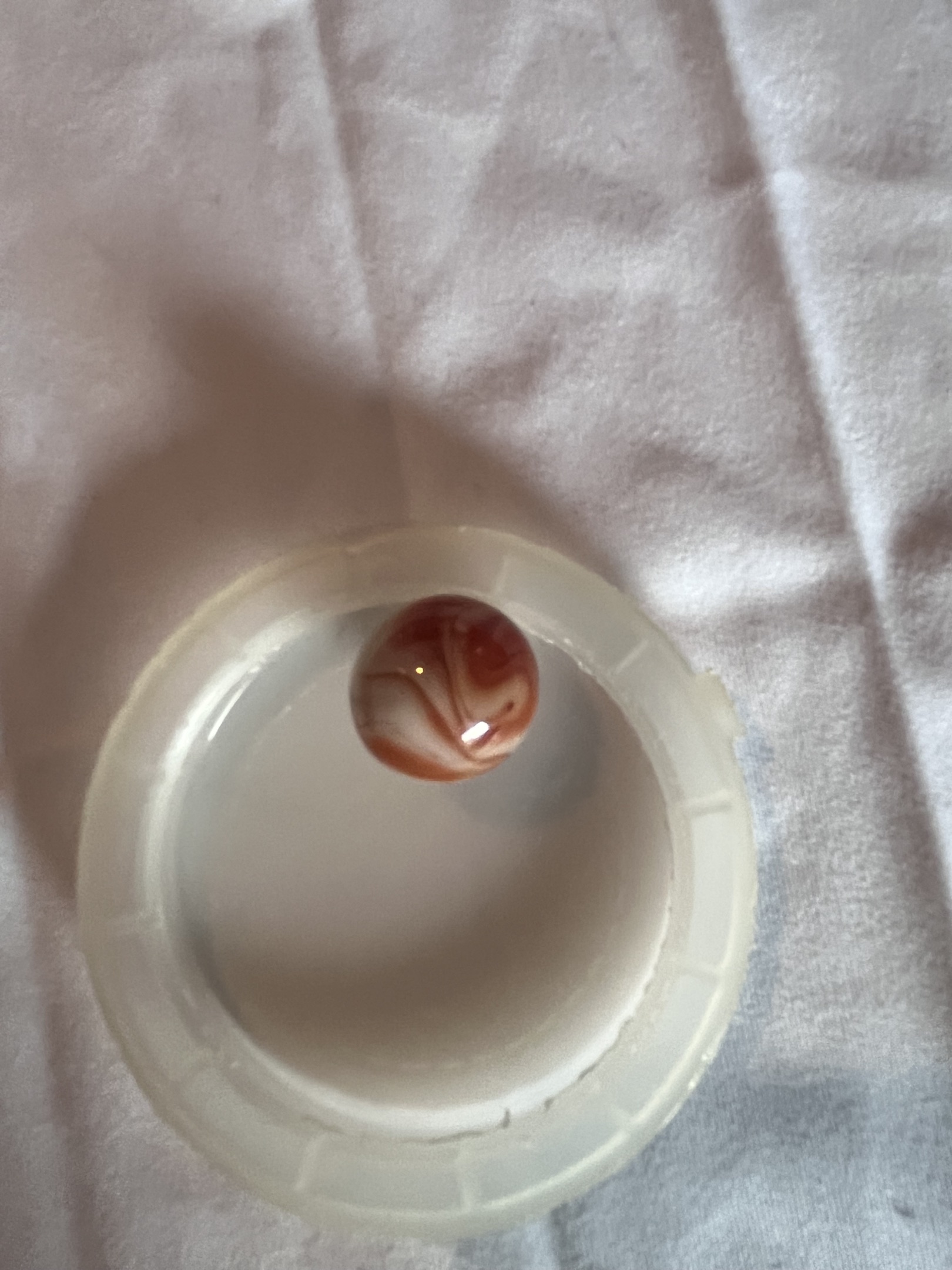 Prize Name / Opaque Red-Orange Swirl by Akro Agate Company, identification view